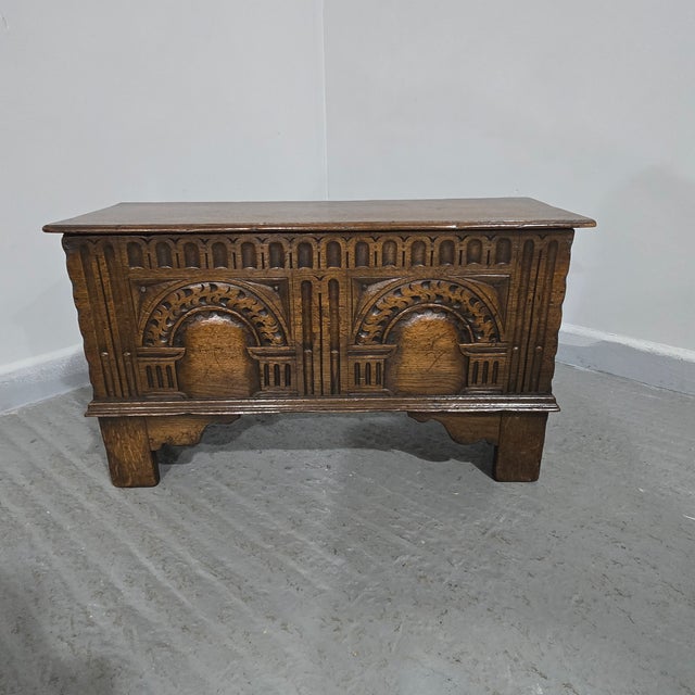 A very smart minature oak coffer with crisp carvings, standing on bracket feet, in excellent overall condition. 17" high...