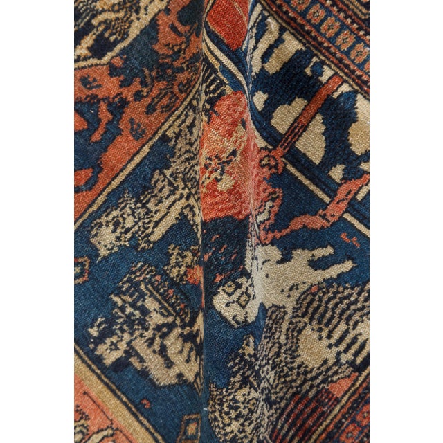 An unusual late 19th century Senneh antique rug having an architectural design of orange and blue panels containing...