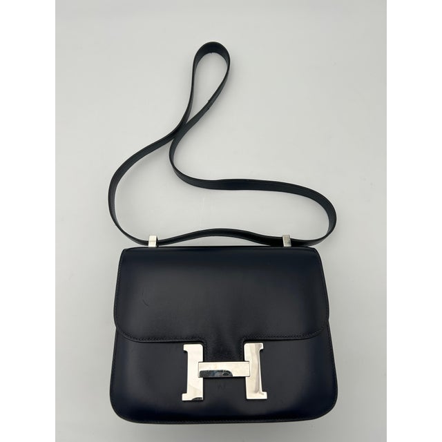 The Blue Hermès Constance Bag is one of the most coveted pieces in the Hermès lineup — a structured, elegant shoulder bag...