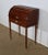 This small solid mahogany and mahogany veneer desk has a cylinder part made of solid mahogany moulded slats, sliding...