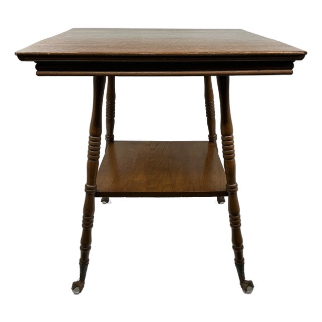 Antique Oak Side Table With Claw Foot Casters – Vintage Two-Tier Occasional Table, Early 1900s Turned Leg Accent Table For Sale