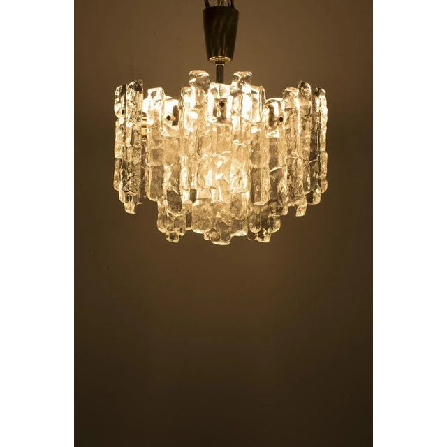 An attractive heavy chandelier with ice glass. The lamp was designed by j.t. Kalmar for franken kg germany in the 1970s....