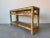 Charming and versatile, this vintage coastal rattan console table exudes natural warmth and organic elegance. Crafted from...