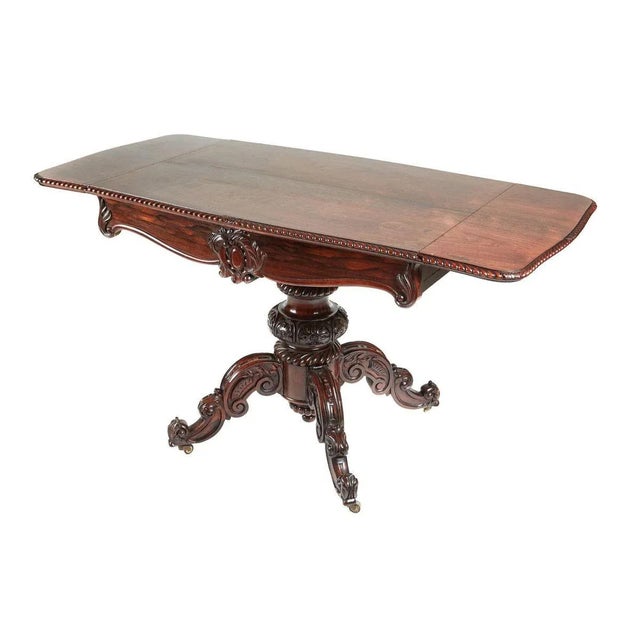 Outstanding antique Victorian carved rosewood sofa table having a wonderful color and a beautiful ornate carved gadrooned...