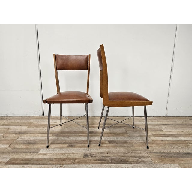 Pair of vintage 1970s chairs with iron and beech frame, and brown upholstered seat and backrest. Perfect for any use, they...