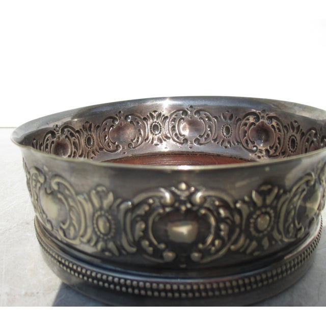Mid-20th-century Gorham silver-plate. A wooden plate bottom from maple or elm wood with turnings around the bottom....