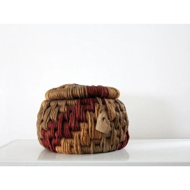This is a vintage coiled rope art basket crafted by Ruth Lescohier in the style of Native American tribes of "Nova...
