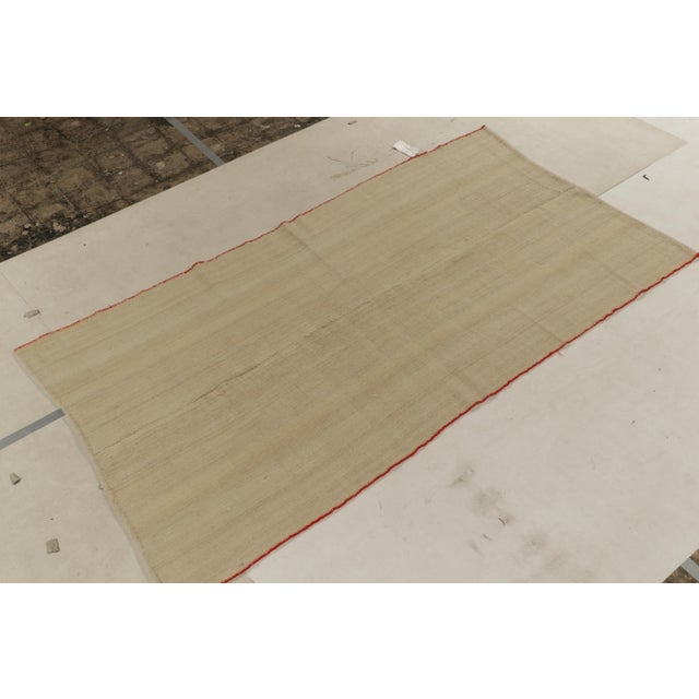 Connoting mid-century aesthetics in handwoven wool, a 5x9 vintage kilim rug from our recently curates flatweaves. This...