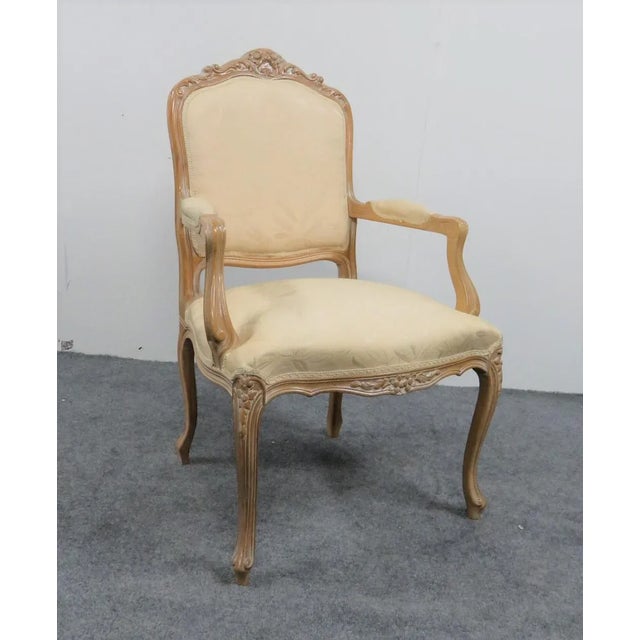 Bleached finish. Carved frame with floral decoration. Cream leaf upholstery.