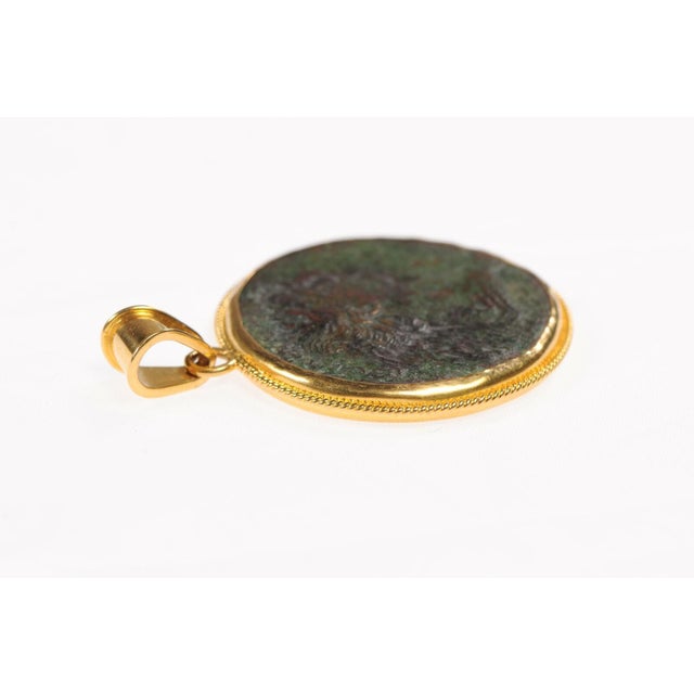 An Authentic Roman Bronze Coin Pendant of Marcus Ulpius Trajanus, the Roman Emperor from 98 AD to 117 AD, set in a 22k...