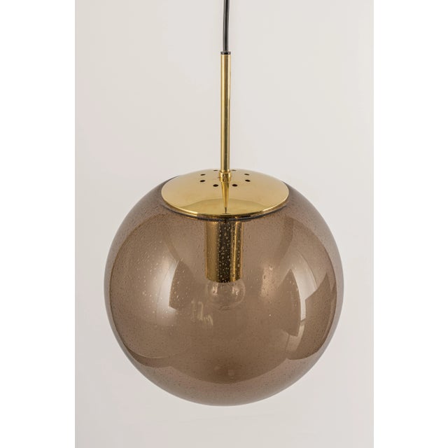 Large hand-made smoky glass ball pendant, manufactured by limburg, germany, circa 1970-1979. sockets: 1 x e27 standard...