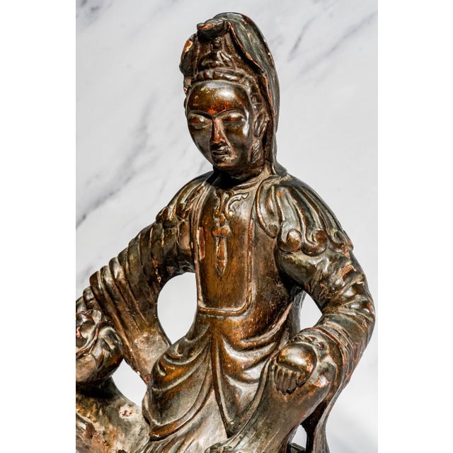 A captivating example of Asian decorative art, this hand-carved wooden sculpture depicts the revered Bodhisattva Guanyin,...