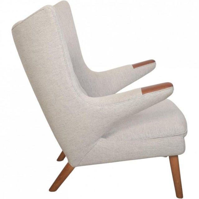 Hans Wegner Papa Bear chair, model AP19, fully upholstered in grey Hallingdal fabric, and with legs and armrests of teak....