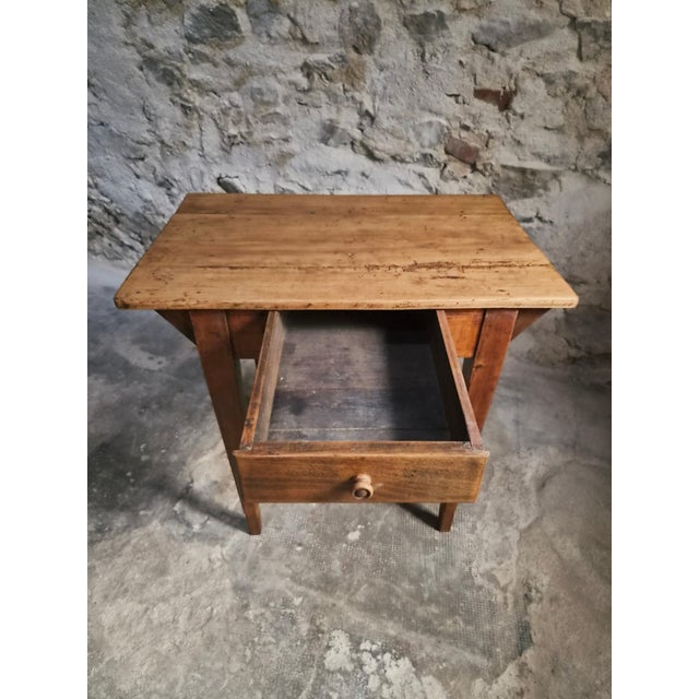 A compact French work table with a matching bistro chair. The table dates from around 1900 and is made of pine and poplar....
