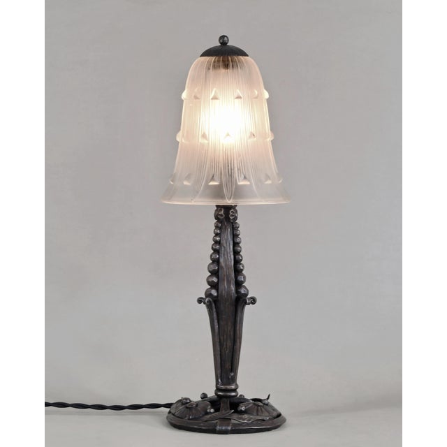 René Lalique A French art deco lamp in wrought iron of excellent quality, crafted circa 1930. It holds a shade by René...