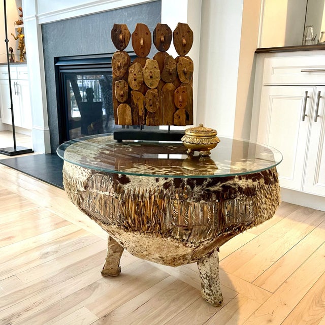 This is a beautiful drum table found across Africa, made from wood and animal hide. A fresh piece of glass has been added...