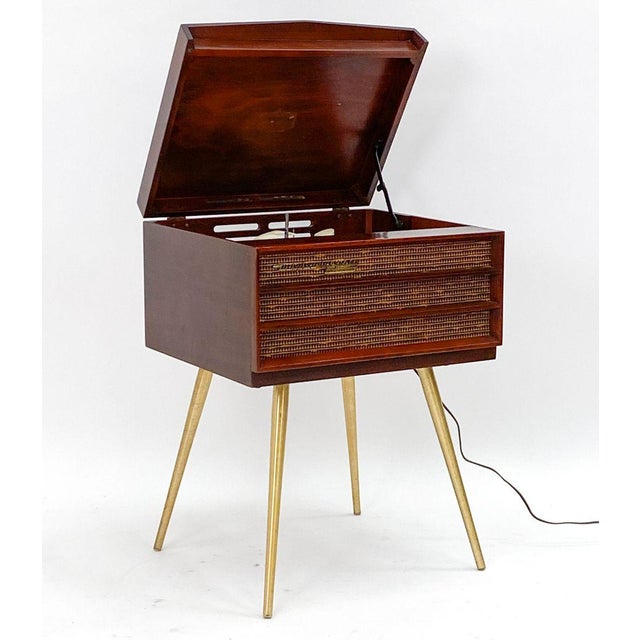 "Orthophonic" record player with brass legs and mahogany case. Model 7-HF5, 1956-57. Paper tag on underside. It turns on...
