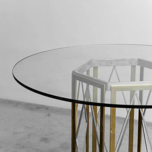 Renato Zevi's round dining table made in the 70s. Chromed and golden metal structure. Base in round glass. Good condition,...