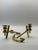 A striking pair of vintage solid brass candlesticks designed as sculptural nautical anchors. Their substantial brass...