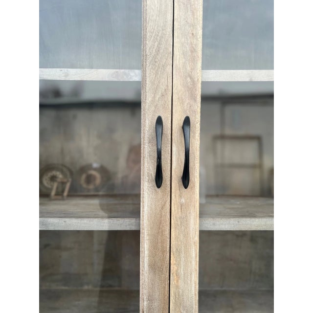 This Coastal large kitchen pantry cupboard features a driftwood finish and is crafted from solid wood with a glass door...