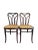 Pair of unique Bentwood Thonet Dining Chairs with cane seats. The delicate arches cross and connect at the rear loop...