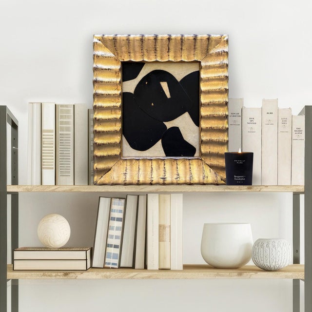 This is a simple bold paper collage in black and ivory set in a vintage gold "ripple" frame. The collage is made from...
