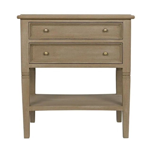Intriguing design elements, like decorative carving atop tapered legs and two slim drawers, elevate the traditionally...