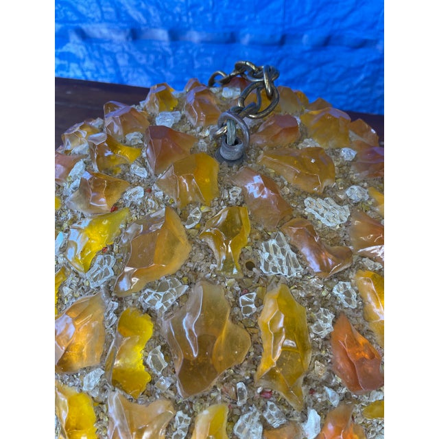 This Mid Century Modern Chunky Lucite Orange Rock Candy hanging Swag Ball from the 1960's is a vintage ceiling light with...