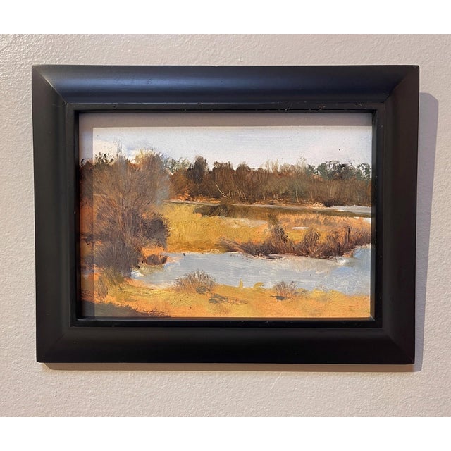 This oil painting captures a serene landscape of Blackmer Lake, where gentle brushstrokes evoke the tranquil interplay...