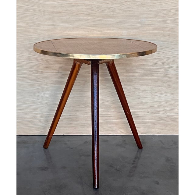 Beautiful vintage side table, Italian style, with a round base in wood brass edge that rests on wood legs. This side table...