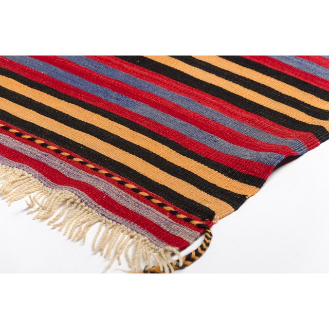 This is a vintage Turkish Oushak rug from the Mid 20th Century. The piece was hand-knotted.