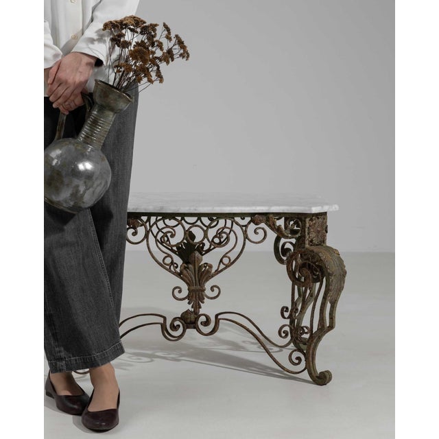 Marble-top wrought iron console in Aged Wrought Iron. Finished in aged wrought iron, this marble-top wrought iron console...