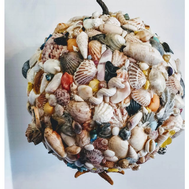 Gorgeous vintage hanging natural seashell sphere sculpture. Hundreds of shells and seashore treasures make up this...