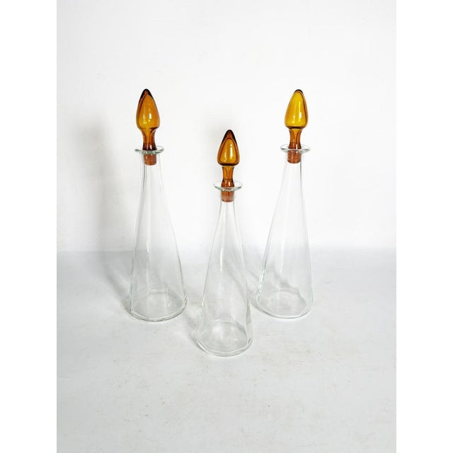 These are the dimensions of a bottle, the slightly larger one. Set of 3 Glass Decanters with Amber Stoppers, France, 1970...