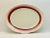 A simple platter with a raised decoration around the edges and a band of color radiating outwards.
