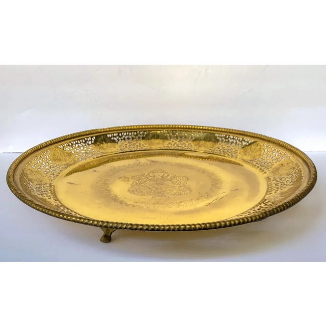 Large and visually unusual pierced brass round footed tray or shallow bowl with a center engraved design of Buddha,...