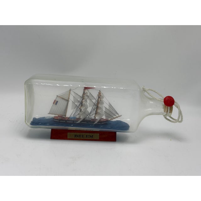 This is a beautifully detailed vintage ship-in-a-bottle depicting the Belém, a classic three-masted sailing ship. The...