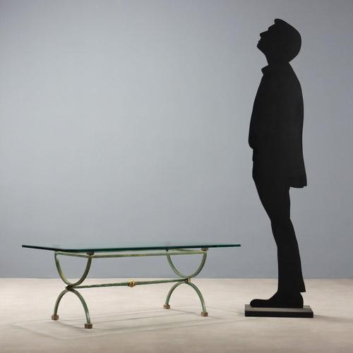 Coffee table in lacquered metal, beveled glass top. This piece is attributed to the mentioned designer/maker. It has no...