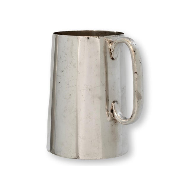 English silverplate trophy mug dated 1922 and engraved for a shot put competition. The tapering cylindrical form features...