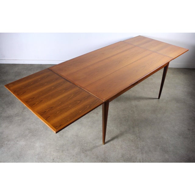 Stunning teak extension dining / conference table made by Niels Moller. Sturdy and built to not only last lifetimes more,...