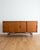 Danish sideboard from the 1950s in teak, approximately 200 cm. Four sliding doors with double vertical handles. The base...