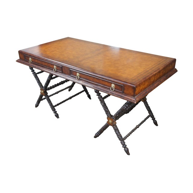 Late 20th Century campaign style desk. Features a rectangular form with brown tooled leather top and two drawers in the...