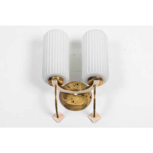 Mid-century double sconces in the manner of Stilnovo; two pairs available. Ceiling fixture listed that matches the sconces.