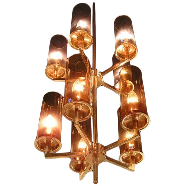 Tall Swedish 1960s chandelier by designer Hans-Agne Jakobsson. Ten light, brass and glass. Five lighter and five darker...