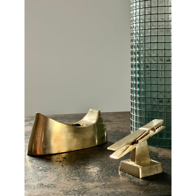 Desk accessories in cast brass; a set of two heavyweight functional pieces to add to a brass collection. A useful tape...