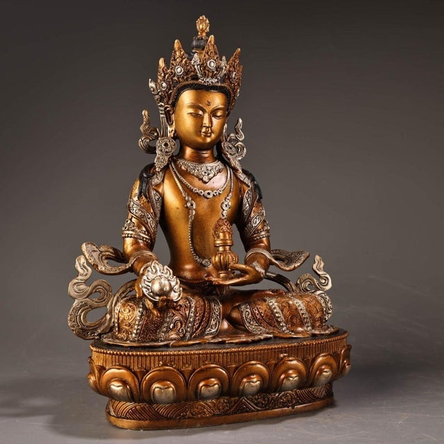 This is a finely crafted antique gilt bronze sculpture of Ksitigarbha Bodhisattva, a revered figure in Tibetan Buddhism....