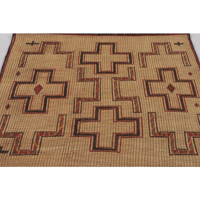 This vintage Moroccan Tuareg square mat, dating to circa 1950-1960, reflects the distinctive craftsmanship of the Tuareg...