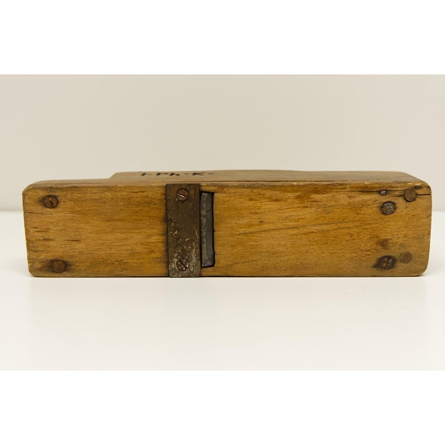 An antique 10" wood hand plane with a beautifully aged, timeworn patina. This particular plane, with its visible "I.Ph.K."...