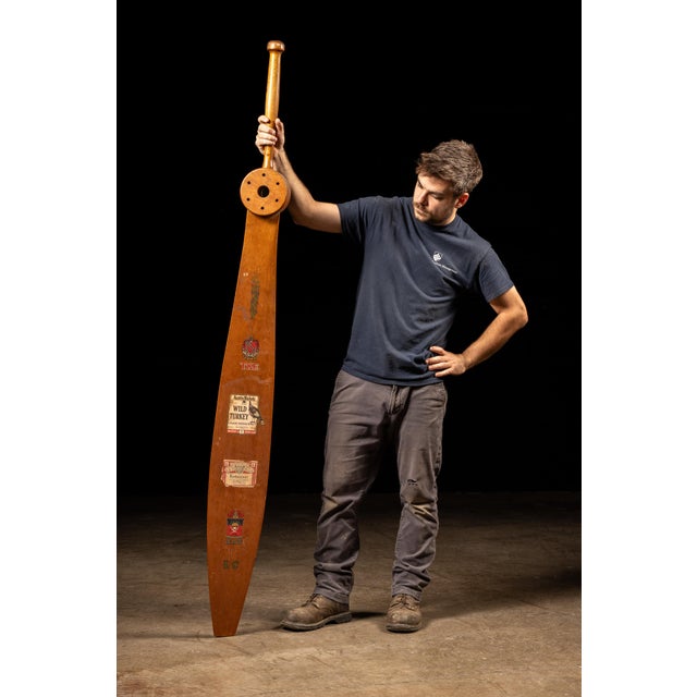 Monumental handmade wooden fraternity paddle dated "FALL 89," featuring an elongated tapered blade, turned handle, and...