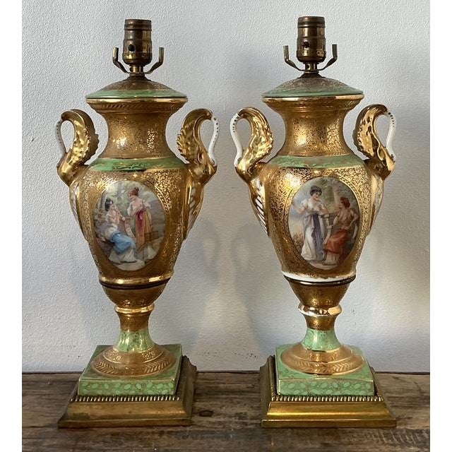This magnificent pair of French Empire-style table lamps offers a masterclass in Neoclassical elegance and mid-century...